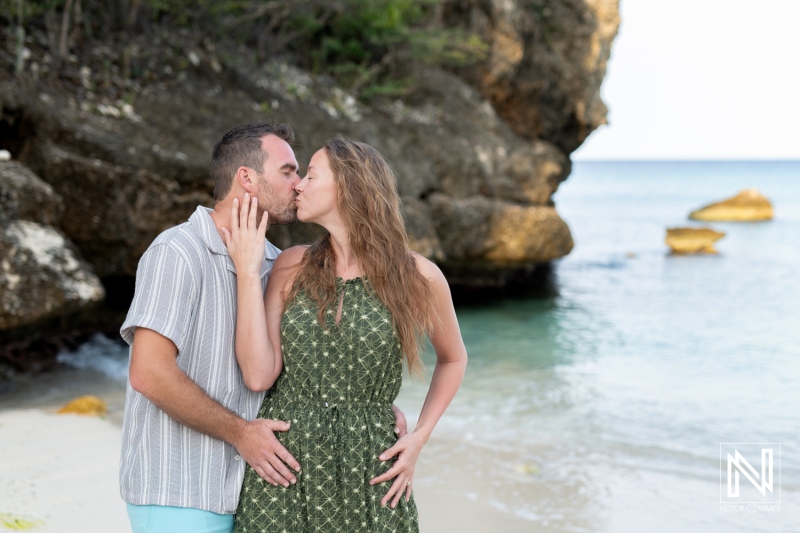 Couple shares a romantic wedding proposal at Daaibooi Beach during a stunning sunrise in Curacao