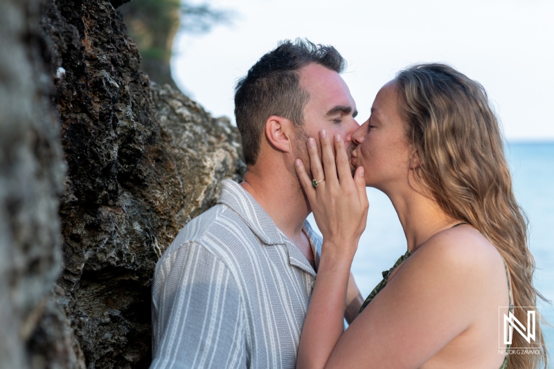 Romantic wedding proposal at sunrise on Daaibooi Beach in Curacao, capturing a couple's intimate moment