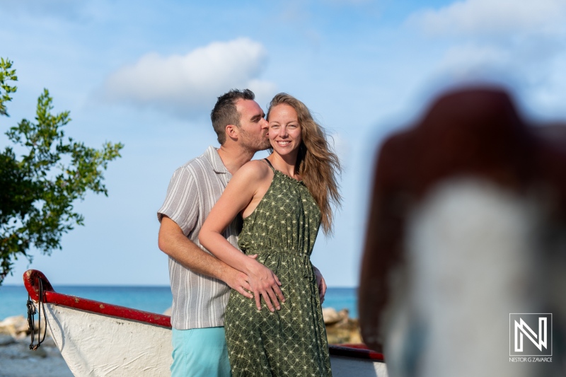 Romantic wedding proposal at Daaibooi Beach in Curacao during a serene sunrise with a happy couple embracing each other