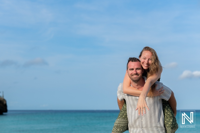 Romantic wedding proposal at Daaibooi Beach in Curacao during sunrise, capturing a couple's unforgettable moment of love