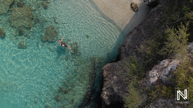 Couple enjoys a romantic wedding proposal at sunrise on the pristine Daaibooi Beach in Curacao, surrounded by breathtaking natural beauty and serene waters