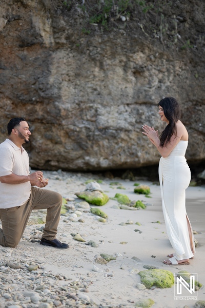 Wedding proposal on Daaibooi Beach in Curacao during sunset with couple on sandy shore