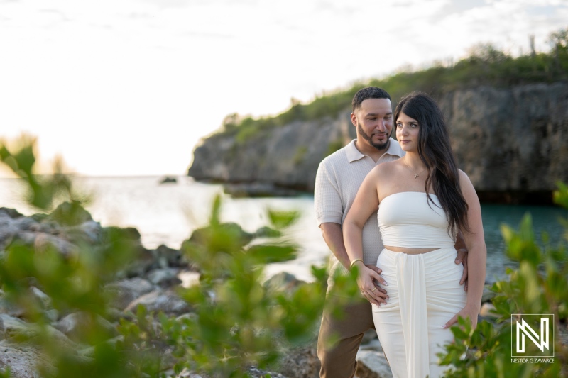 Couple shares a wedding proposal moment at Daaibooi Beach in Curacao during sunset