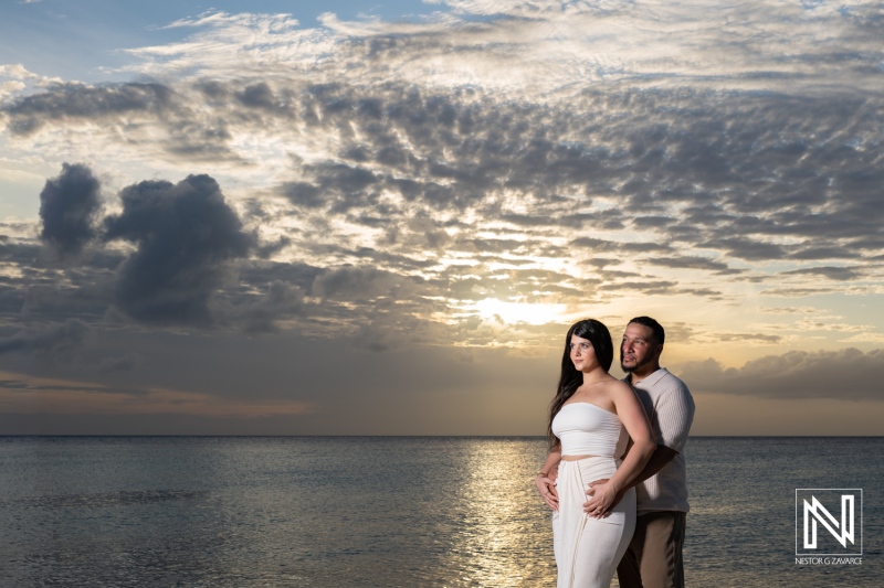 Couple celebrates wedding proposal at Daaibooi Beach during sunset in Curacao