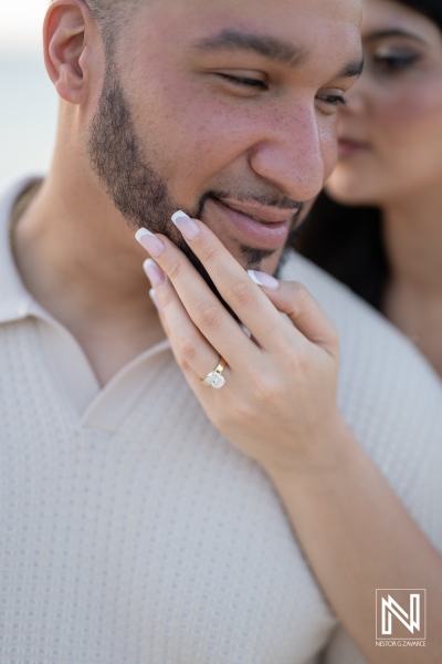 Couple enjoys a wedding proposal moment at Daaibooi Beach in Curacao