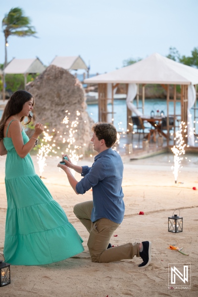 Couple at Baoase Luxury Resort during a wedding proposal with fireworks and romantic setting in Curacao