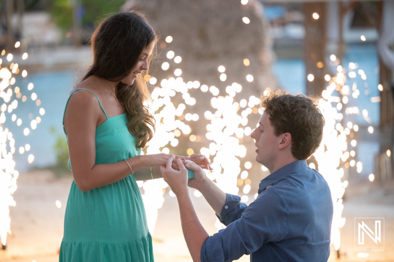 Wedding proposal at Baoase Luxury Resort in Curacao during sunset with fireworks in the background