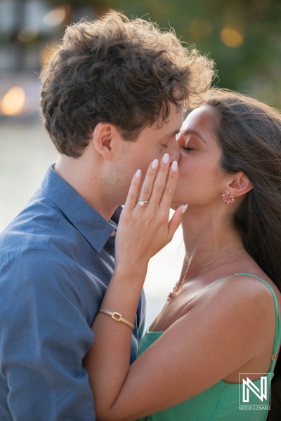 Couple shares a kiss during wedding proposal at Baoase Luxury Resort in Curacao on a special evening