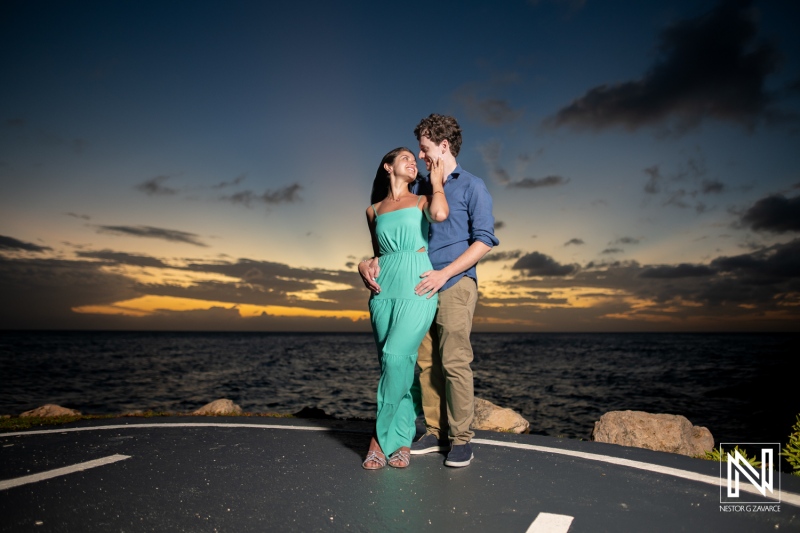 Couple celebrates a wedding proposal at Baoase Luxury Resort in Curacao with sunset in the background