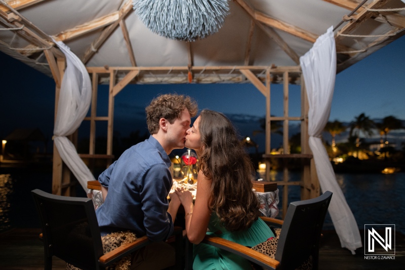 Couple shares a special moment during a wedding proposal at Baoase Luxury Resort in Curacao at night
