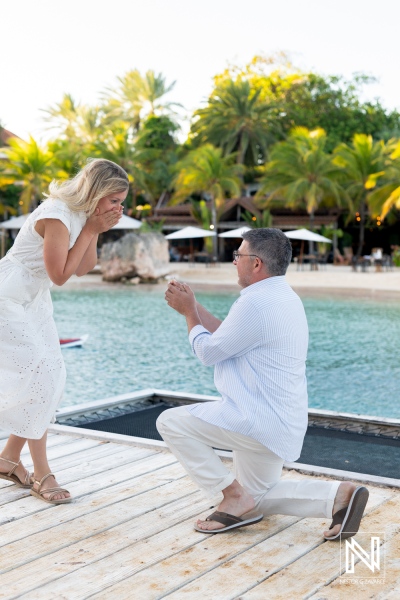 Couple enjoys a wedding proposal at Baoase Luxury Resort in Curacao by the water during sunset