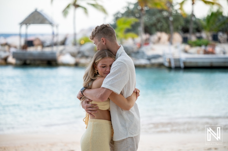 Couple shares a tender moment during a wedding proposal at Baoase Luxury Resort in Curacao, capturing romance and joy by the beach