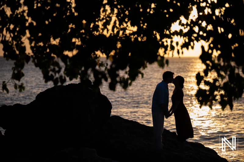 Couple has wedding proposal at Knip beach in Curacao during sunset by the water