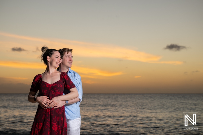 Wedding proposal takes place at Knip, Curacao during sunset with a couple smiling and enjoying the moment