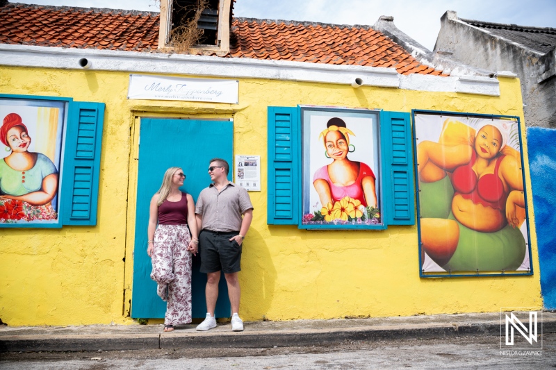 Couple enjoys wedding proposal moment in colorful Willemstad during bright afternoon