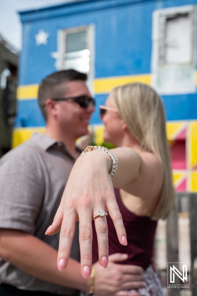 Couple has wedding proposal at Willemstad with colorful background in Curaçao