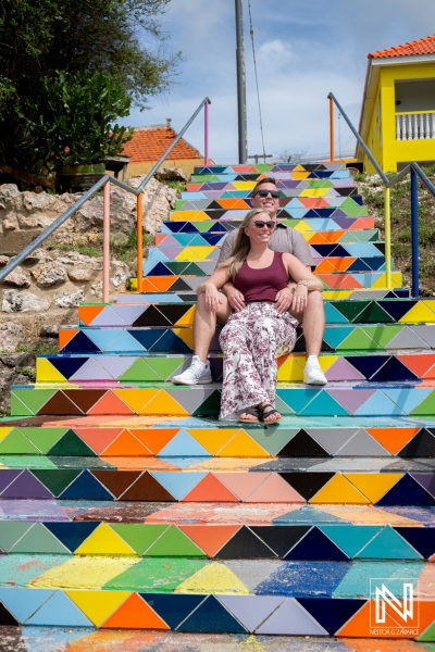 Couple celebrates wedding proposal on colorful stairs in Willemstad, Curacao, capturing joyful moment at unique location