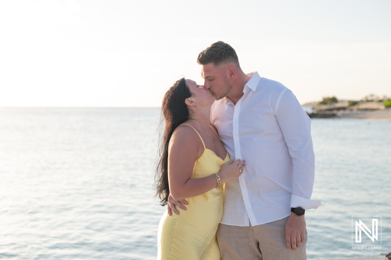 Couple shares a romantic moment during wedding proposal at Curacao Marriott Beach Resort at sunset