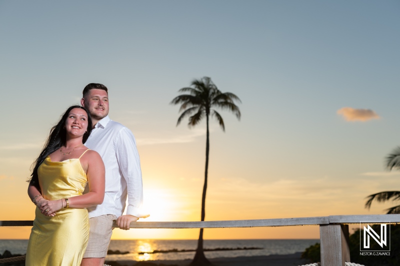 Couple shares a romantic wedding proposal at sunset in Curacao Marriott Beach Resort