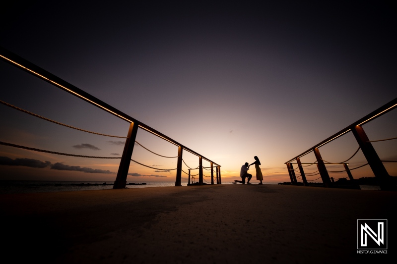 Romantic wedding proposal at sunset on the pier in Curacao Marriott Beach Resort, capturing a memorable moment in paradise