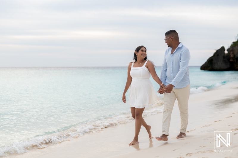 Wedding proposal at Cas Abao Beach in Curacao with couple walking on the sand at sunset
