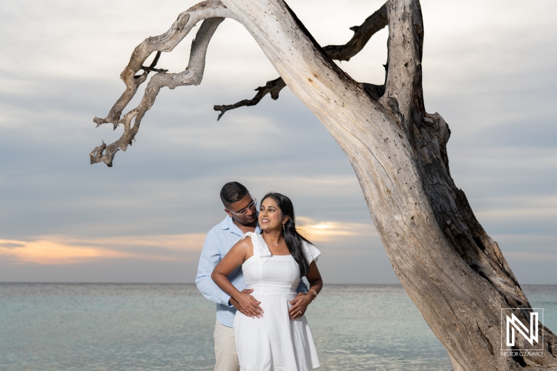 Wedding proposal happens at Cas Abao Beach in Curacao during sunset by the water as a couple embraces