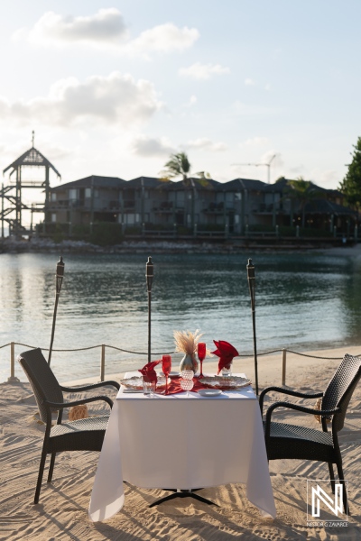 Couple enjoys a romantic sunset wedding proposal at Avila Beach Hotel in Curacao, creating unforgettable memories by the water