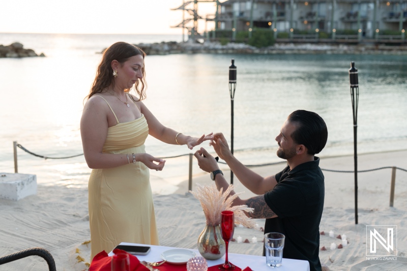 Couple enjoys a romantic sunset wedding proposal at Avila Beach Hotel in Curacao with a backdrop of serenity and love