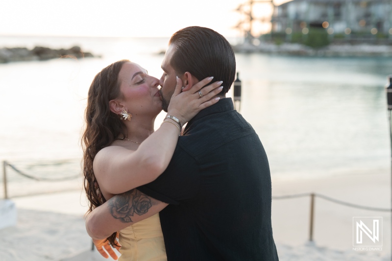 Couple shares a romantic wedding proposal at Avila Beach Hotel during a stunning sunset in Curacao