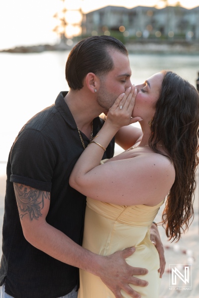 Romantic proposal at sunset on the beach at Avila Beach Hotel in Curacao, capturing a couple's love and joy during this special moment