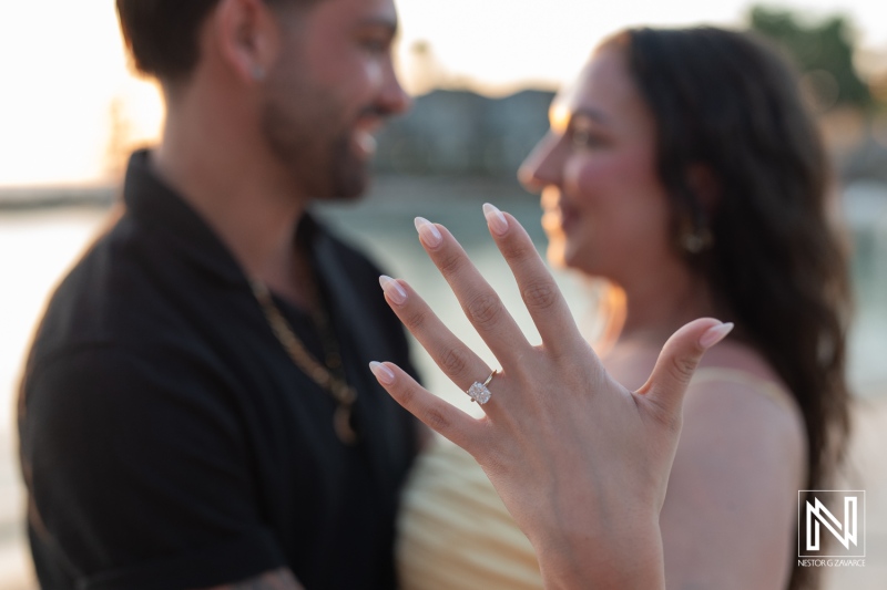Couple celebrating a romantic wedding proposal at sunset near Avila Beach Hotel in Curacao