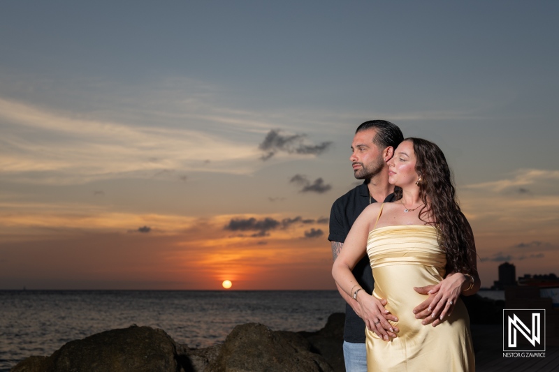 Couple shares a romantic sunset wedding proposal at Avila Beach Hotel in Curacao, creating a cherished moment together