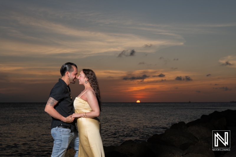 Romantic wedding proposal at sunset on Avila Beach in Curacao, capturing a couple’s love and commitment with the ocean as a backdrop