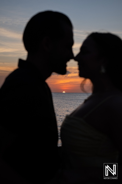 Couple shares a romantic wedding proposal at sunset on the beautiful shores of Avila Beach Hotel in Curacao