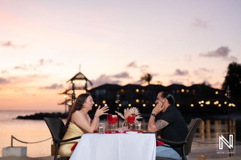 Couple celebrates romantic wedding proposal at Avila Beach Hotel during a stunning sunset in Curacao