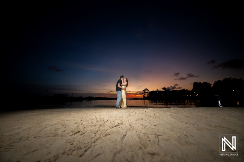 Couple shares a memorable wedding proposal at sunset on the beach in Curacao, creating a romantic moment under beautiful skies