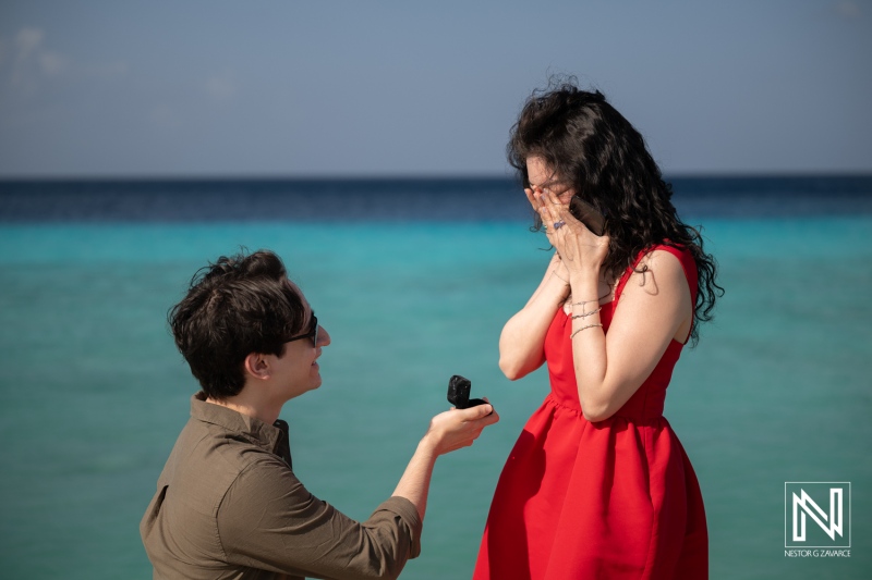 Couple enjoys a wedding proposal at Playa Porto Mari in Curacao by the beach