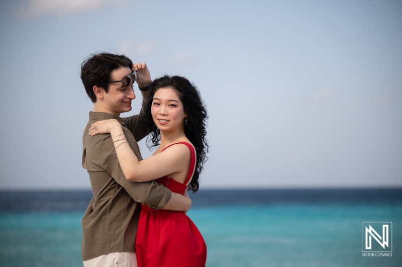 Couple enjoys a wedding proposal at Playa Porto Mari in Curacao by the sea