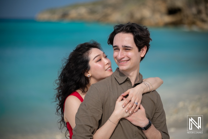 Couple enjoys a wedding proposal moment at Playa Porto Mari in Curacao during bright daylight