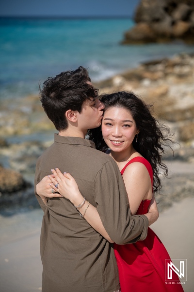 Couple has wedding proposal at Playa Porto Mari in Curacao by the beach while standing close together