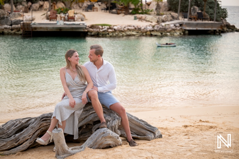 Couple enjoys a wedding proposal at Baoase Luxury Resort in Curacao with a backdrop of the beach and calm water