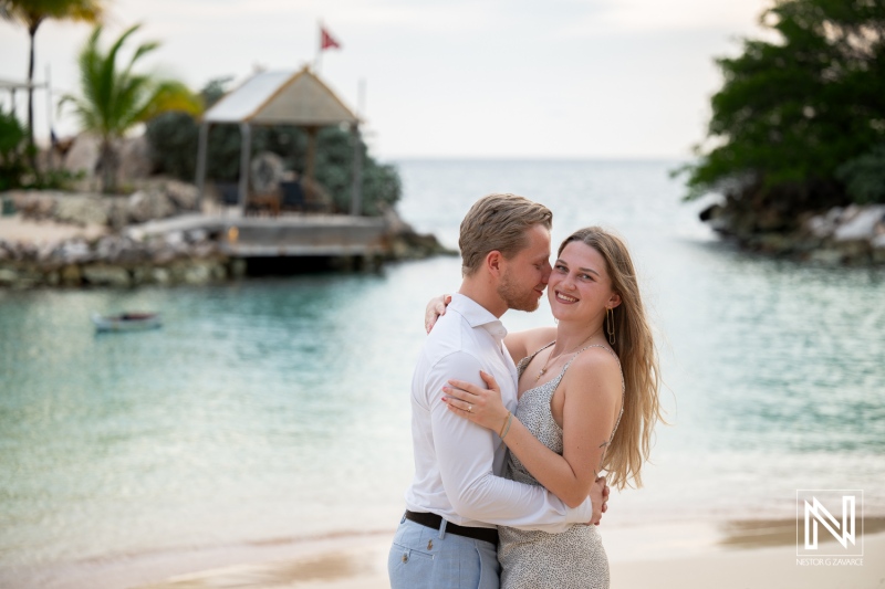 Couple enjoys wedding proposal at Baoase Luxury Resort in Curacao during sunset by the beach
