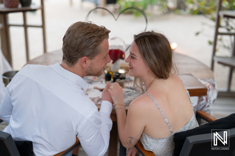 Couple enjoys a wedding proposal at Baoase Luxury Resort in Curacao during a romantic dinner