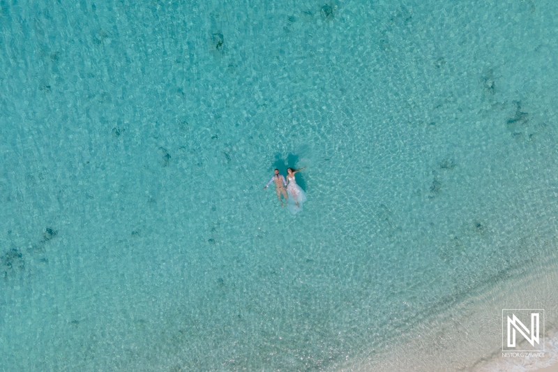 Couple Enjoying a Serene Moment Together While Floating in Crystal-Clear Turquoise Waters on a Sunny Day at a Tropical Beach