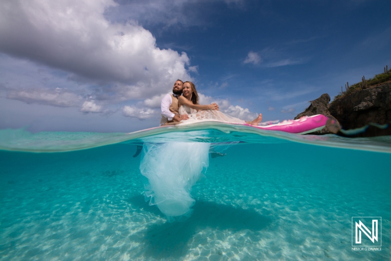 Couple Celebrating Their Wedding on a Tropical Beach With Clear Turquoise Waters and a Dramatic Sky, Showcasing Joy and Love During a Beautiful Sunset