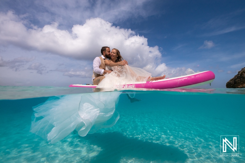 Couple Enjoying a Romantic Moment on a Paddleboard in Crystal Clear Water During a Sunny Day at a Tropical Beach