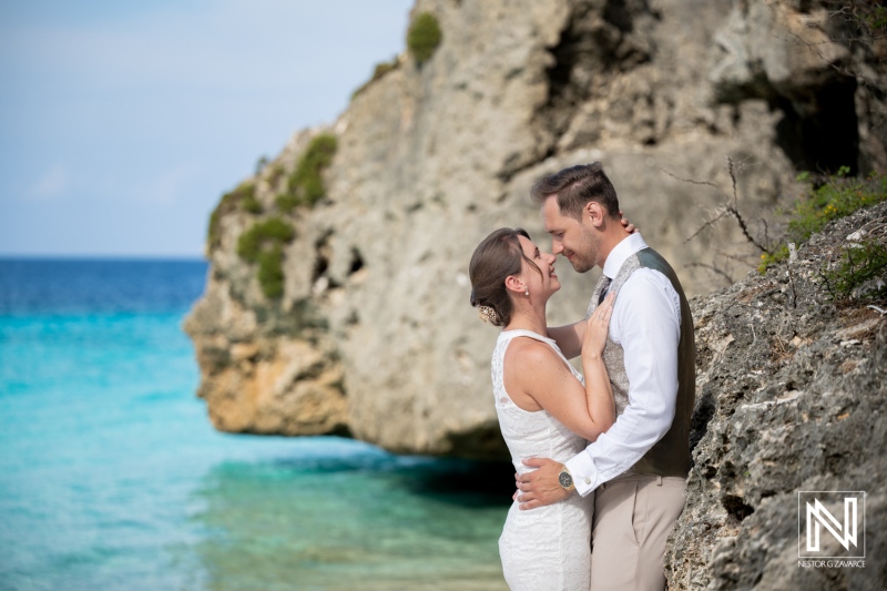 Couple enjoys a Trash the Dress session at Cas Abao Beach in Curacao on a sunny day with a beautiful ocean view