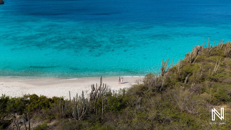 Couple enjoys trash the dress session at Cas Abao Beach in Curacao during bright sunny day
