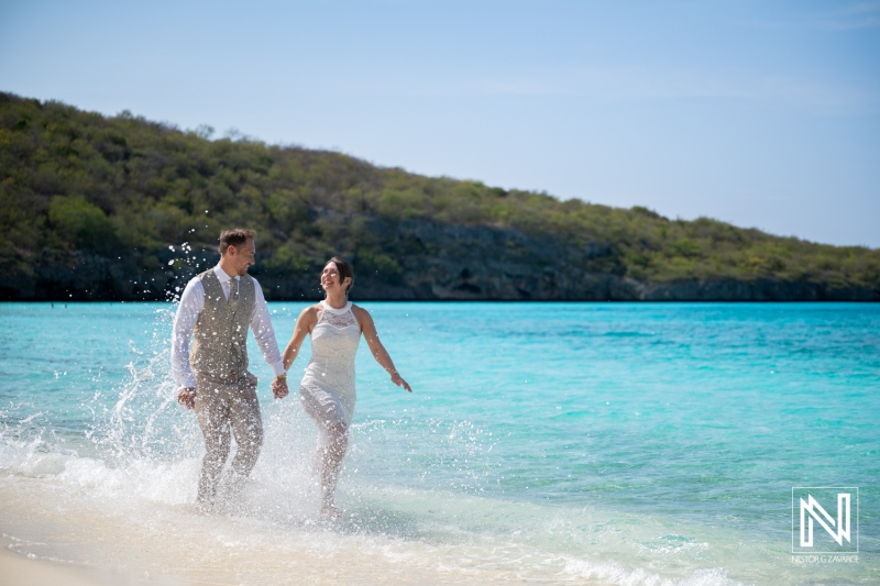 Couple enjoying trash the dress session at Cas Abao Beach in Curacao during sunny afternoon