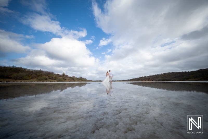 Trash the dress session in Curacao with couple walking in water